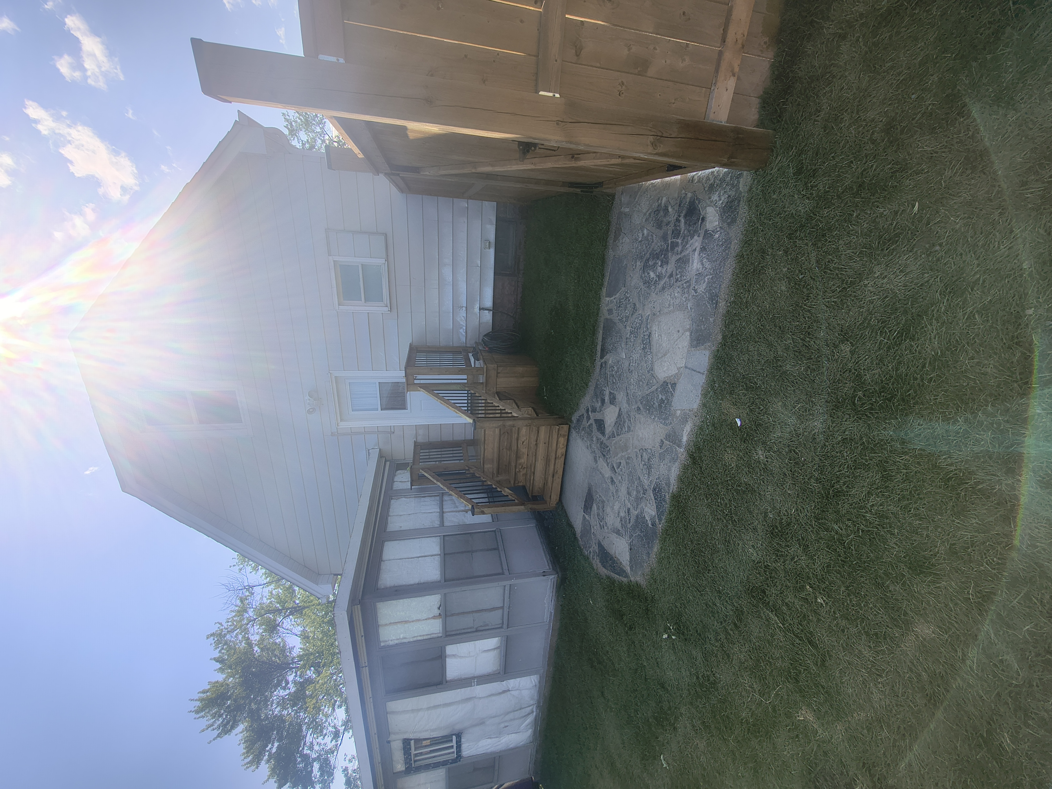 Rear yard after &mdash; regraded with a new deck, flagstone patio and fresh sod