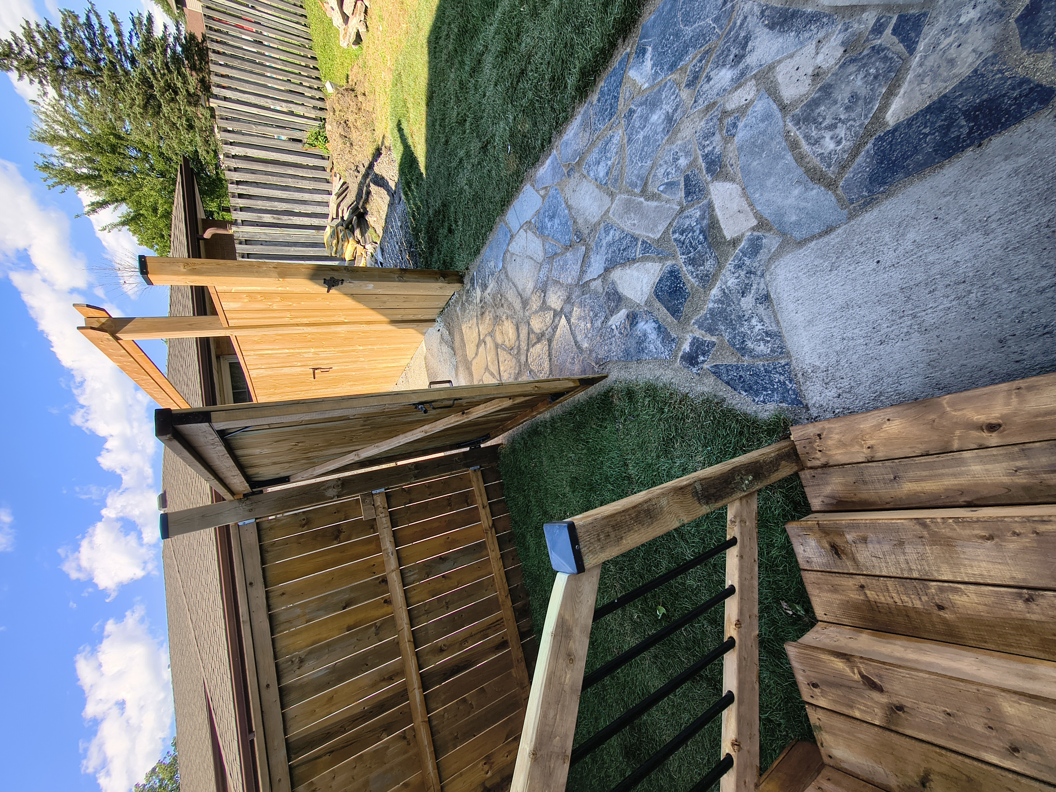 Natural flagstone walkway leading back to the new cedar gate