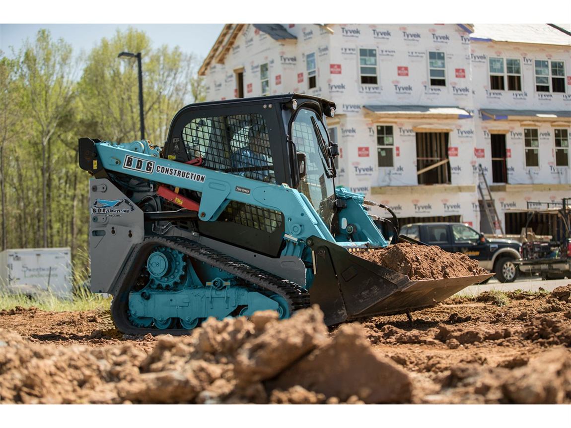 BDG branded skid steer backfilling and grading a site