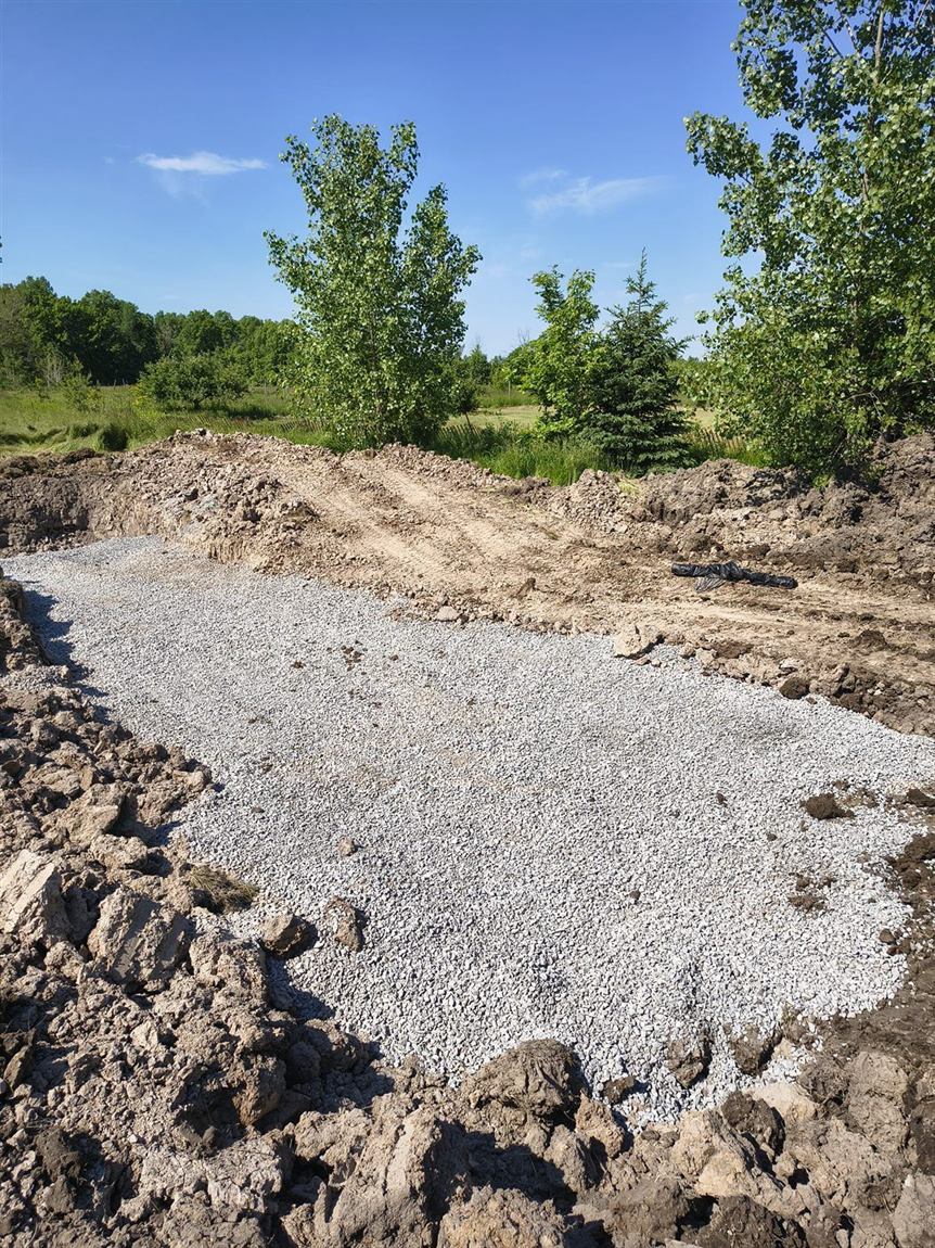 Clear-stone drainage bed on a graded site
